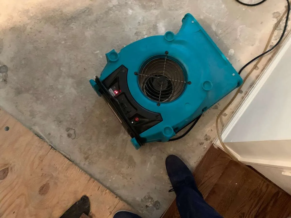 Air mover drying subfloor during Commercial Water Damage Restoration in Carlstadt